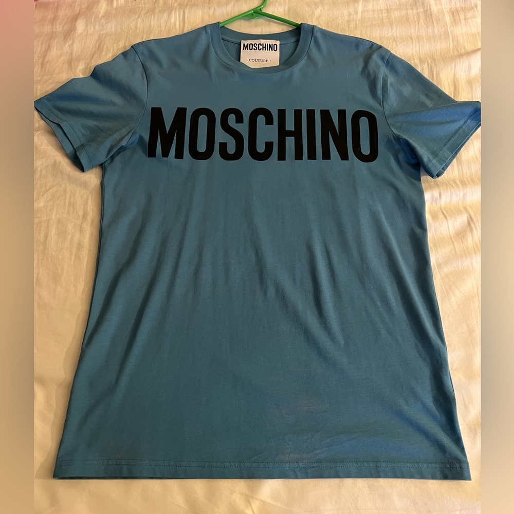 Moschino men T-shirt blue color size Small in good condition 100%cotton